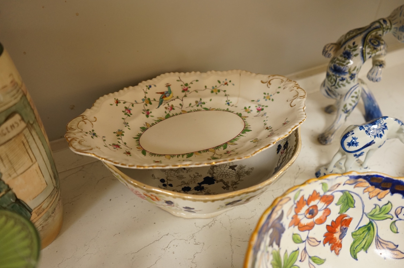 A collection of French, Japanese and English ceramics to include Royal Doulton Dickensware, Imari bowls and a faience glazed cat